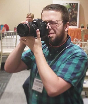 mdoulos holding camera