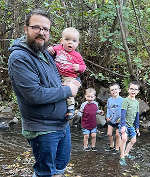 mdoulos with sons playing in creek